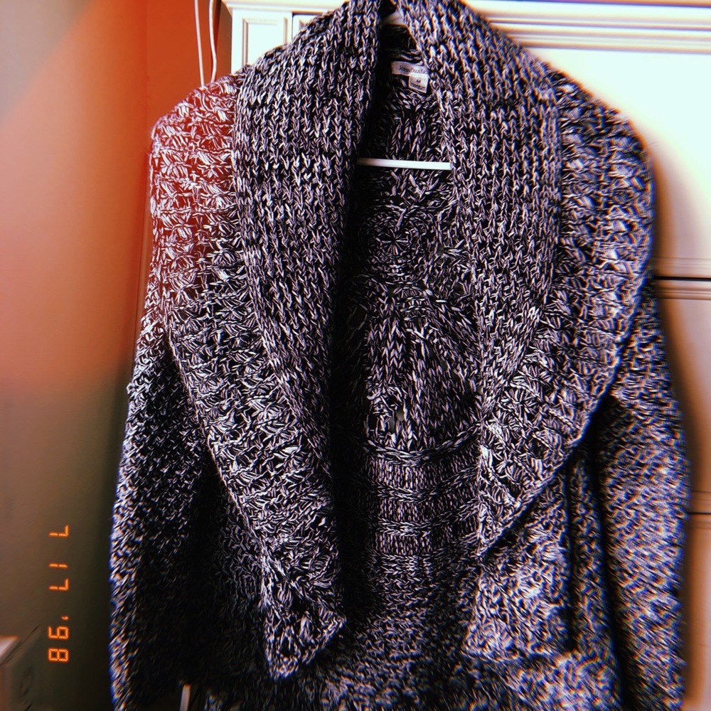 Knitted poncho with sleeves.